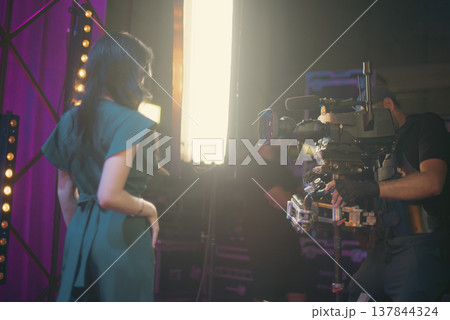 Steadicam Operator Filming Beautiful Woman in Studio with Copy Space Steadicam Operator Filming Beautiful Woman in Studio with Copy Space 137844324