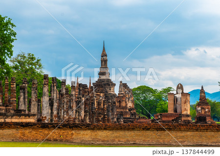 Landscape of Buddha statue and pagoda in Wat Mahathat temple Sukhothai Historical Park, Thailand Landscape of Buddha statue and pagoda in Wat Mahathat temple Sukhothai Historical Park, Thailand 137844499
