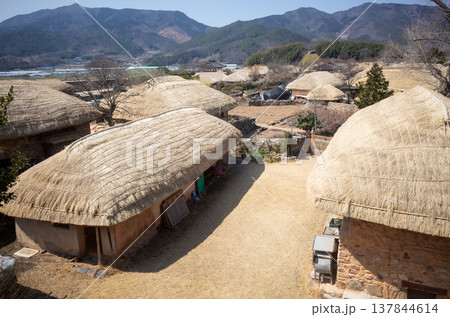 Traditional Korean village courtyard with thatched houses 137844614