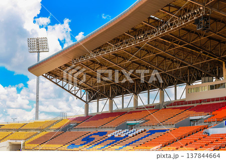 stadium with a roof, spotlights and seating for watching and cheering. 137844664