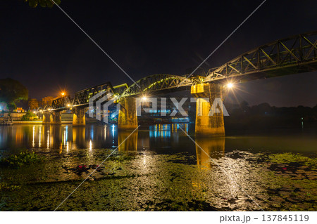 Landscape of Bridge River Kwai at Kanchanaburi, Thailand in night time. Is a famous place and a tourist destination Landscape of Bridge River Kwai at Kanchanaburi, Thailand in night time. Is a famous place and a tourist destination 137845119