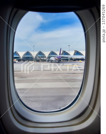 Modern airport with planes waiting to pick up passengers, view from the plane window 137845269