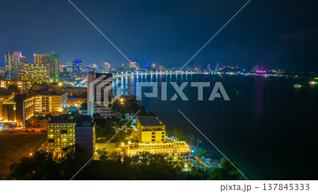 Panoramic view of Pattaya city from high angle with beach and buildings in night time. It is a landmark and popular tourist destination. Panoramic view of Pattaya city from high angle with beach and buildings in night time. It is a landmark and popular tourist destination. 137845333
