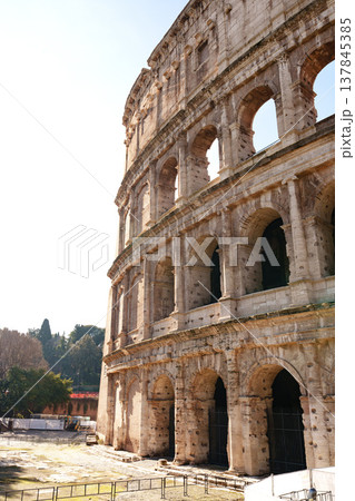 Visitors explore the Colosseum in Rome during a sunny afternoon in the early spring 137845385