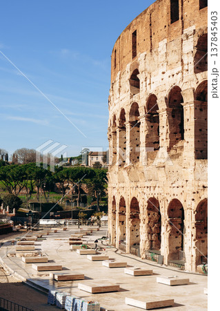 Scene showing the colosseum in Rome with empty areas for visitors during daytime Scene showing the colosseum in Rome with empty areas for visitors during daytime 137845403