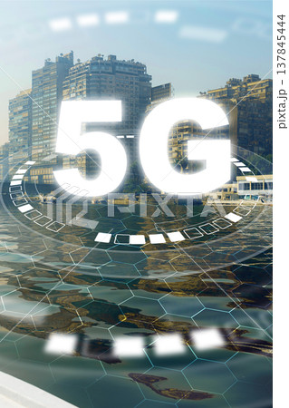 5G internet connections reflect in the waters of a busy cityscape by the river 137845444