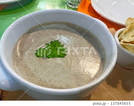 Cream of mushroom soup with croutons on a board Cream of mushroom soup with croutons on a board 137845655
