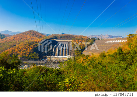 Srinakarin Dam the power station with large mountains and many trees at Kanchanaburi, Thailand. To generate electricity in the western region of the country Srinakarin Dam the power station with large mountains and many trees at Kanchanaburi, Thailand. To generate electricity in the western region of the country 137845711