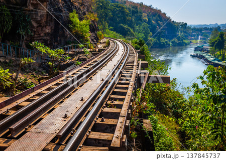 The Death Railway crossing kwai river in Kanchanaburi Thailand. Important landmark and destination to visiting and world war II history builted The Death Railway crossing kwai river in Kanchanaburi Thailand. Important landmark and destination to visiting and world war II history builted 137845737