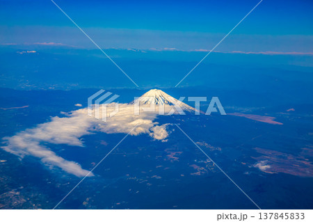 Mount Fuji seen from an airplane on a beautiful blue day with snow on the peak Mount Fuji seen from an airplane on a beautiful blue day with snow on the peak 137845833