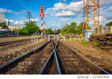 railway traffic light at an old transfer point with power lines and wooden tracks as a backdrop. 137845844