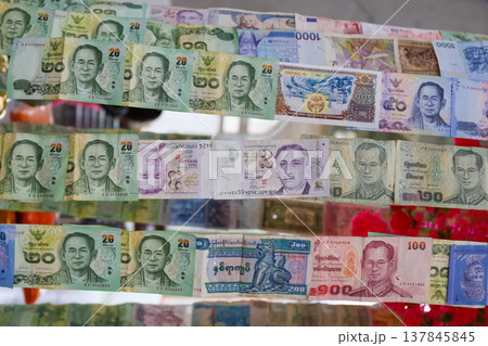 collection of banknotes in various ASEAN currencies stapled together. 137845845