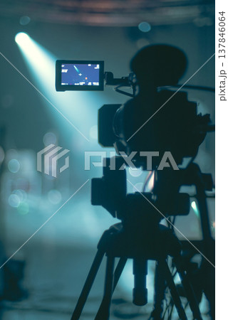Professional Video Camera Silhouette with Stage Spotlight and Copy Space Professional Video Camera Silhouette with Stage Spotlight and Copy Space 137846064