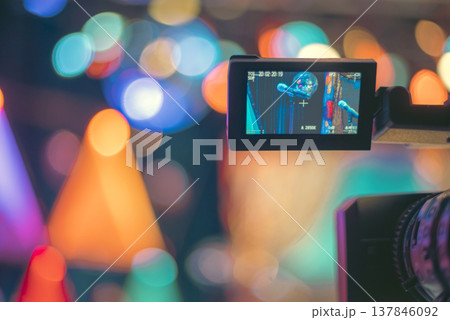 Professional Video Camera Recording Live Show with Colorful Bokeh and Copy Space 137846092