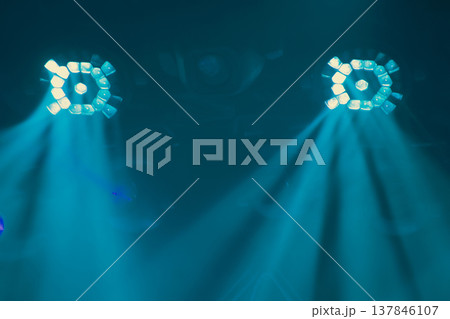 Symmetry of Two Professional Teal Stage Spotlights with Beams and Copy Space 137846107