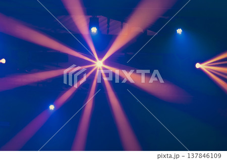 Abstract Stage Spotlight with Radial Orange Beams and Blue Accents with copy space 137846109