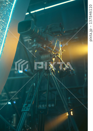 Professional Broadcasting Camera on Tripod in Cinematic Teal and Orange Lighting with copy space Professional Broadcasting Camera on Tripod in Cinematic Teal and Orange Lighting with copy space 137846110