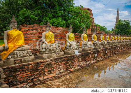 Many ancient Buddha images are lined up in rows at Wat Yai Chaimongkol Worawihan, Ayutthaya Historical Park, Thailand. Many ancient Buddha images are lined up in rows at Wat Yai Chaimongkol Worawihan, Ayutthaya Historical Park, Thailand. 137846152