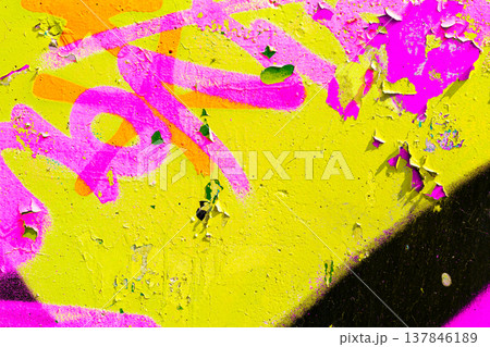 Yellow and Pink Graffiti Texture on Peeling Urban Wall Yellow and Pink Graffiti Texture on Peeling Urban Wall 137846189