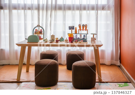 Children's playroom with wooden toys and non-toxic paints helps develop children with wooden tables and chairs. Children's playroom with wooden toys and non-toxic paints helps develop children with wooden tables and chairs. 137846327