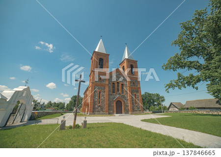 Neo-Romanesque Church in Lazduny with white gate and blue sky with copy space 137846665