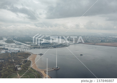 Cloudy weather illuminates St. Petersburgs skyline, showcasing rivers, bridges, and urban architecture in a stunning aerial perspective. Cloudy weather illuminates St. Petersburgs skyline, showcasing rivers, bridges, and urban architecture in a stunning aerial perspective. 137846807