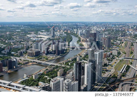 Vibrant skyline of Moscow features contemporary buildings and a winding river reflecting a bustling urban environment, captured on a sunny day. Vibrant skyline of Moscow features contemporary buildings and a winding river reflecting a bustling urban environment, captured on a sunny day. 137846977