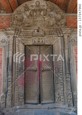 Ancient Wooden Carved Door in Nepal Temple with Intricate Details and Copy Space Ancient Wooden Carved Door in Nepal Temple with Intricate Details and Copy Space 137847960