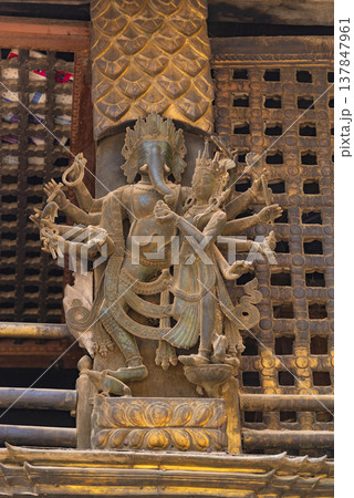 Lord Ganesha and Wife Wood Carving in Nepalese Temple with Copy Space 137847961