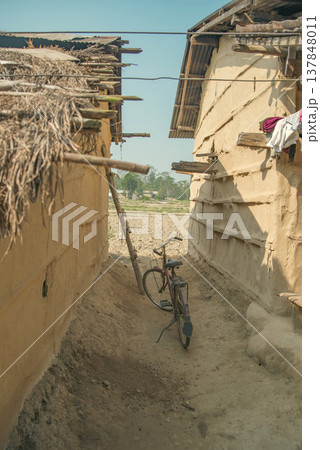 Old Bicycle in Narrow Alley Between Traditional Mud Houses in Nepal with copy space Old Bicycle in Narrow Alley Between Traditional Mud Houses in Nepal with copy space 137848011