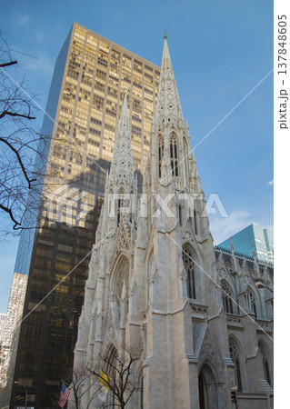 St. Patrick's Cathedral against Modern Glass Skyscraper in New York City with Sky Copy Space 137848605