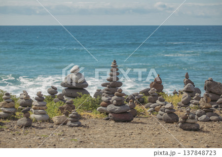 Zen stone towers balanced on sea coast with copy space in sky and ocean 137848723