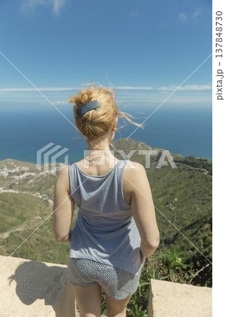 Young woman tourist admiring scenic ocean view from Anaga mountains in Tenerife with copy space Young woman tourist admiring scenic ocean view from Anaga mountains in Tenerife with copy space 137848730