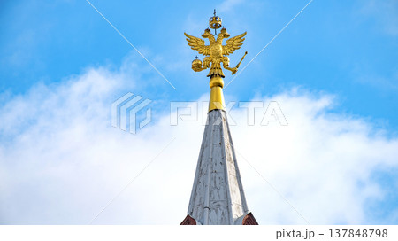 Golden Russian Double-Headed Eagle on Spire with Blue Sky Copy Space 137848798