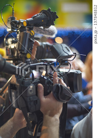Professional Video Camera Operator Filming Live Event with Copy Space for Media Concept Professional Video Camera Operator Filming Live Event with Copy Space for Media Concept 137848812