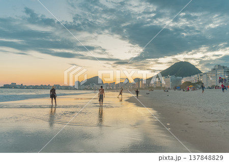 People Reflecting on Copacabana Beach at Sunset in Rio de Janeiro with Copy Space 137848829