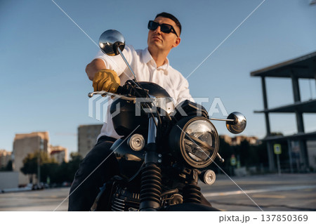 Ready to drive. Man is outdoors with his motorcycle Ready to drive. Man is outdoors with his motorcycle 137850369