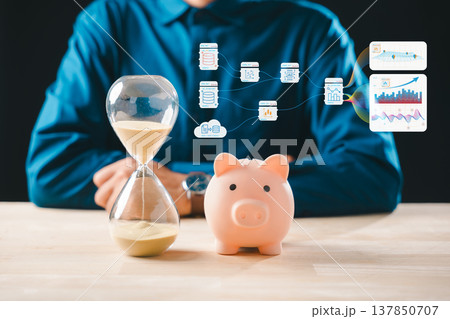 Hourglass showing time value for money saving, piggy bank concept for finance investing, market stock data analytics, digital technology driving investment growth purchase decisions 137850707