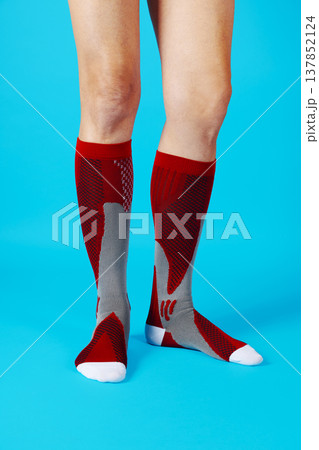 a man wearing red compression socks 137852124