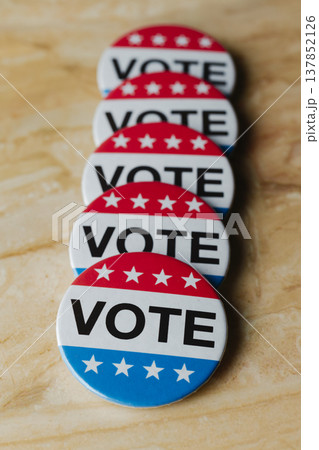 row of vote badges on a marble surface row of vote badges on a marble surface 137852126