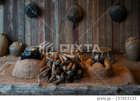 A rustic Aka tribal in Northern Thailand kitchen with vintage cookware and wood logs 137853137
