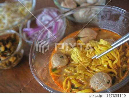 Khao Soi, Northern Thai coconut curry noodles with meat balls and various ingredients 137853140