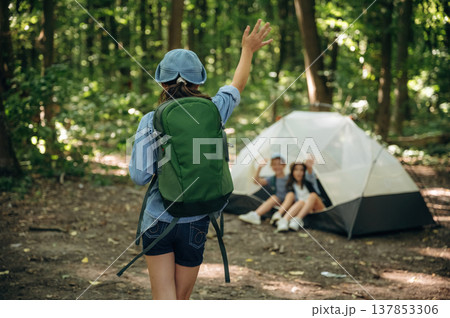 By the tent. Girls kids are in the forest, hike conception 137853306