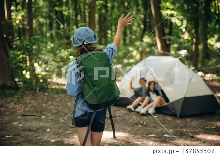 By the tent. Girls kids are in the forest, hike conception 137853307