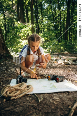 Young girl hiker is in the forest Young girl hiker is in the forest 137853824