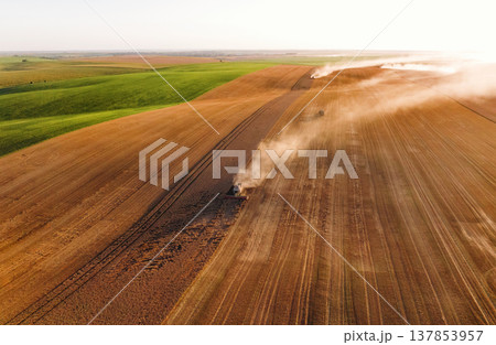 Rural non urban scene, on the field. Agricultural machine harvesting wheat Rural non urban scene, on the field. Agricultural machine harvesting wheat 137853957