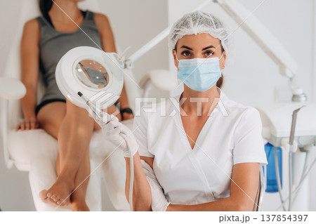 Female podiatrist with woman client in clinic 137854397