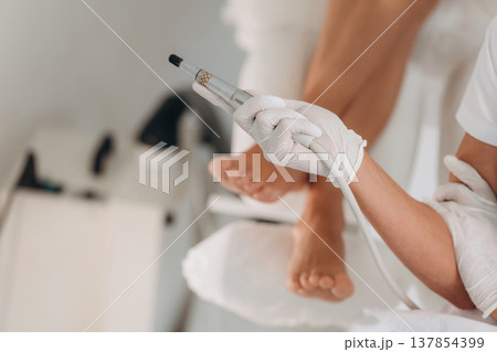 Close up view of podiatrist that is holding equipment in the clinic 137854399