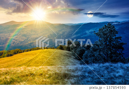 mountain landscape on autumn equinox. day meet night. sun and moon over amazing highland woods. grassy meadow under epic sky. countryside scenery picture with beech forest on a hill behind the pasture mountain landscape on autumn equinox. day meet night. sun and moon over amazing highland woods. grassy meadow under epic sky. countryside scenery picture with beech forest on a hill behind the pasture 137854593