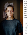 Natural portrait of a teen girl after a shower, with a towel on her head and earphones. Home lifestyle image for themes of morning routine, self care, natural skin and teenage everyday life. 137855012